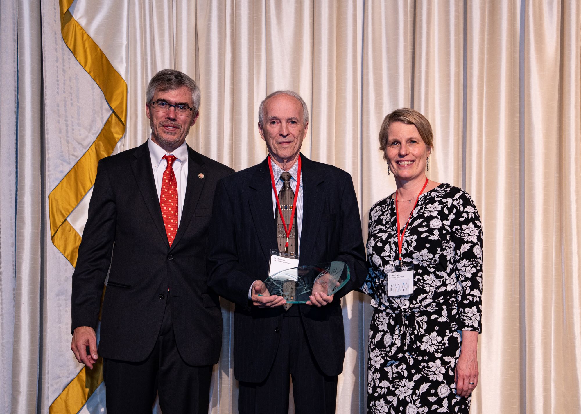 Posed photo of Frank Lloyd Wright Building Conservancy board president Chuck Henderson, Jerry Heinzeroth, and Conservancy Executive Director Barbara Gordon, with Jerry holding the Wright Spirit Award