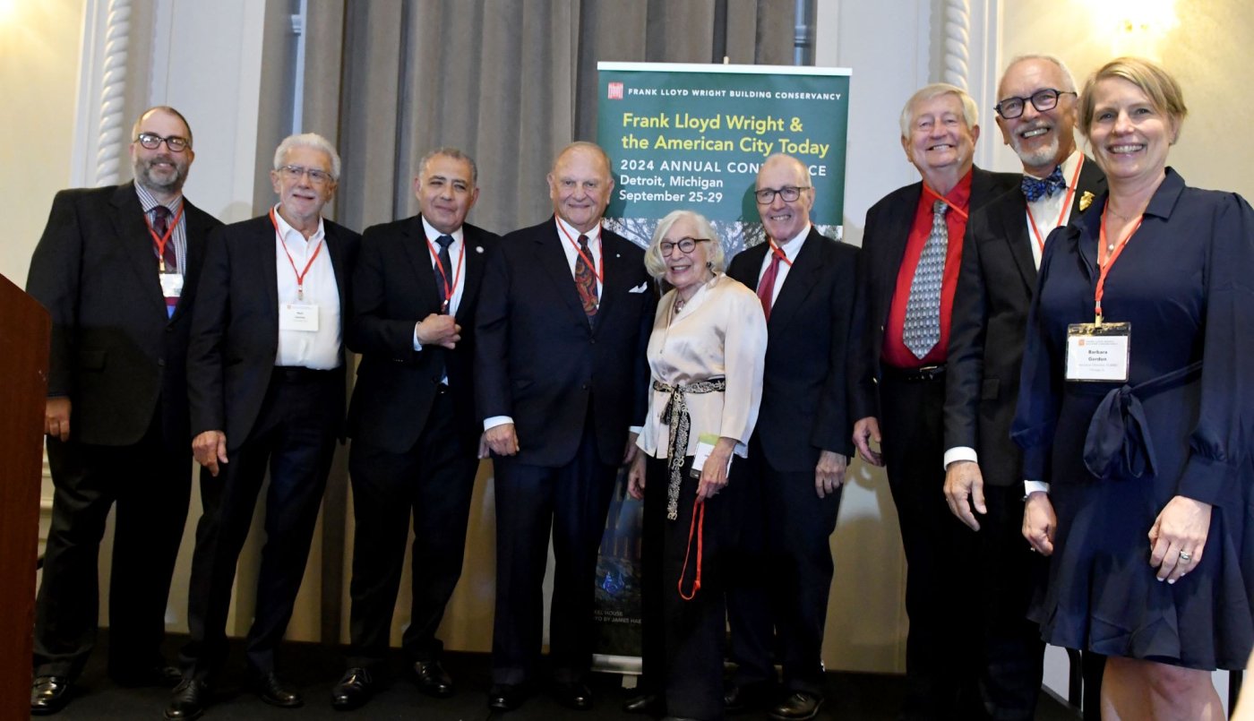 Posed group photo of the 2024 Wright Spirit Award honorees after the awards ceremony, with the 2024 conference banner in the background