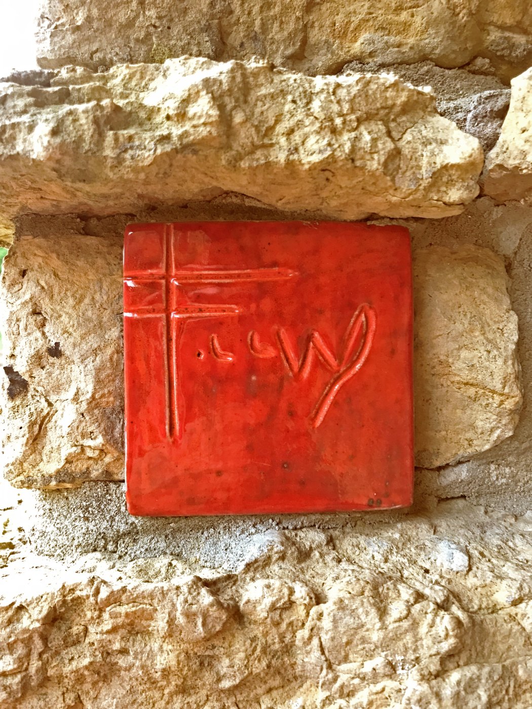 Red ceramic tile with Frank Lloyd Wright's signature